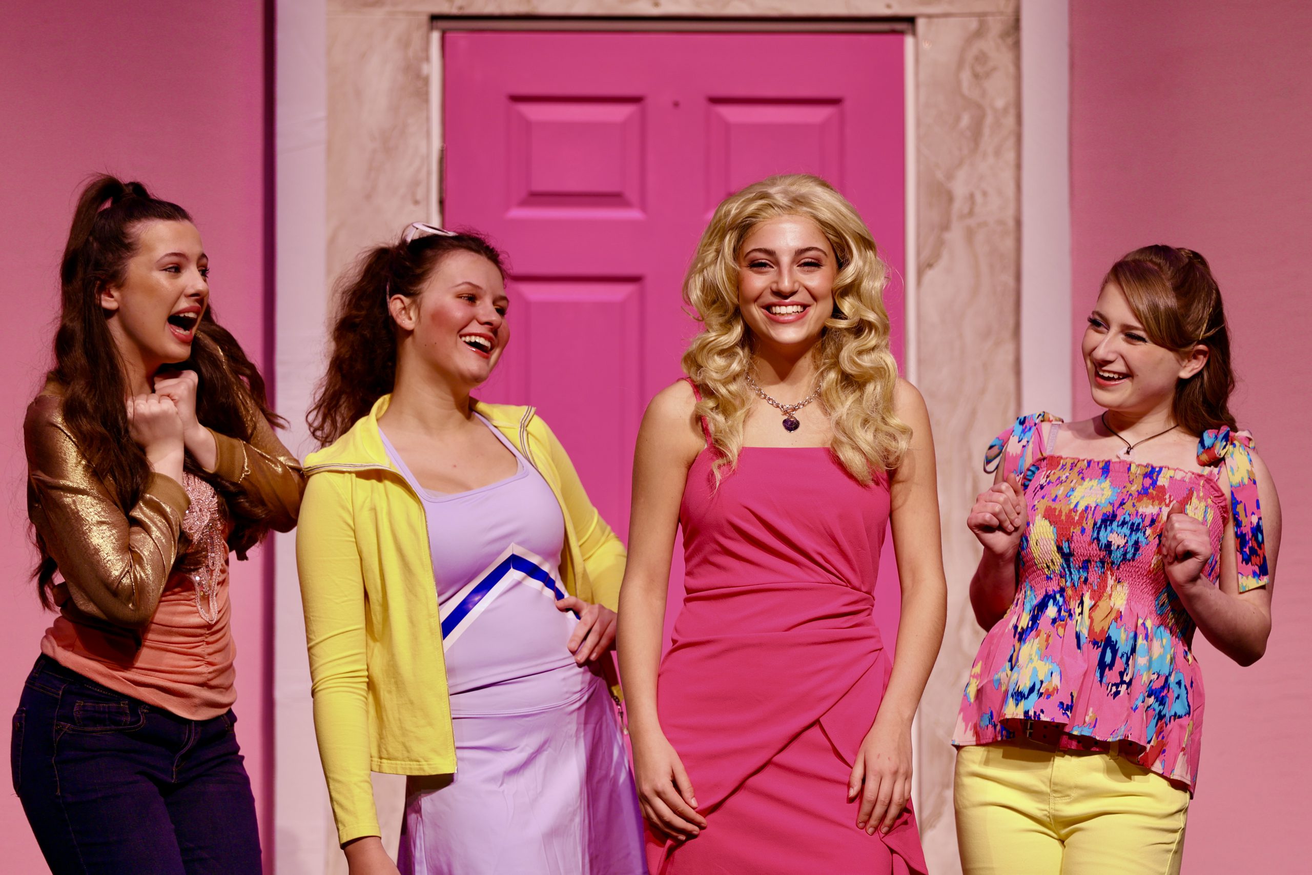 four students perform on stage