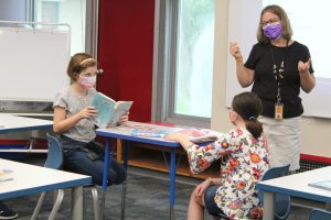 teacher teaching in a classroom to students