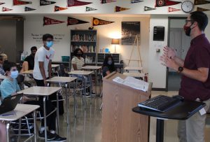 teacher teaching in a classroom to students