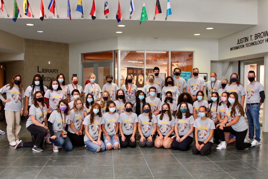 students and teachers pose for hispanic heritage month