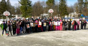 Photo of Slingerlands fifth grade students jumping up and down, celebrating shout out