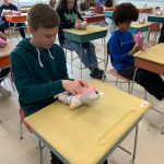 students taking care of dolls