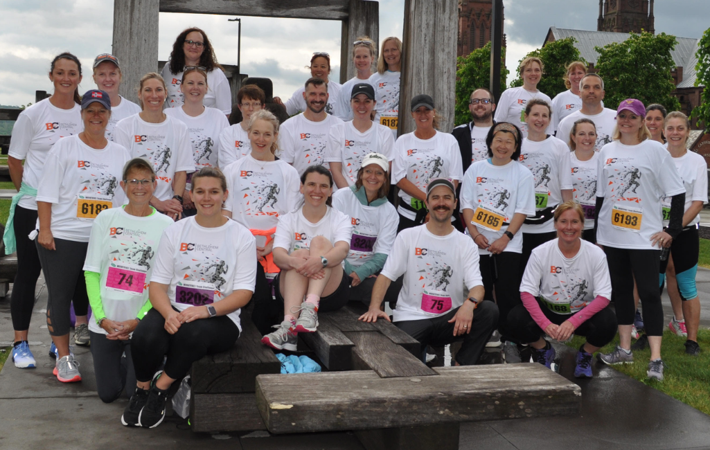 group of adults in white tshirts