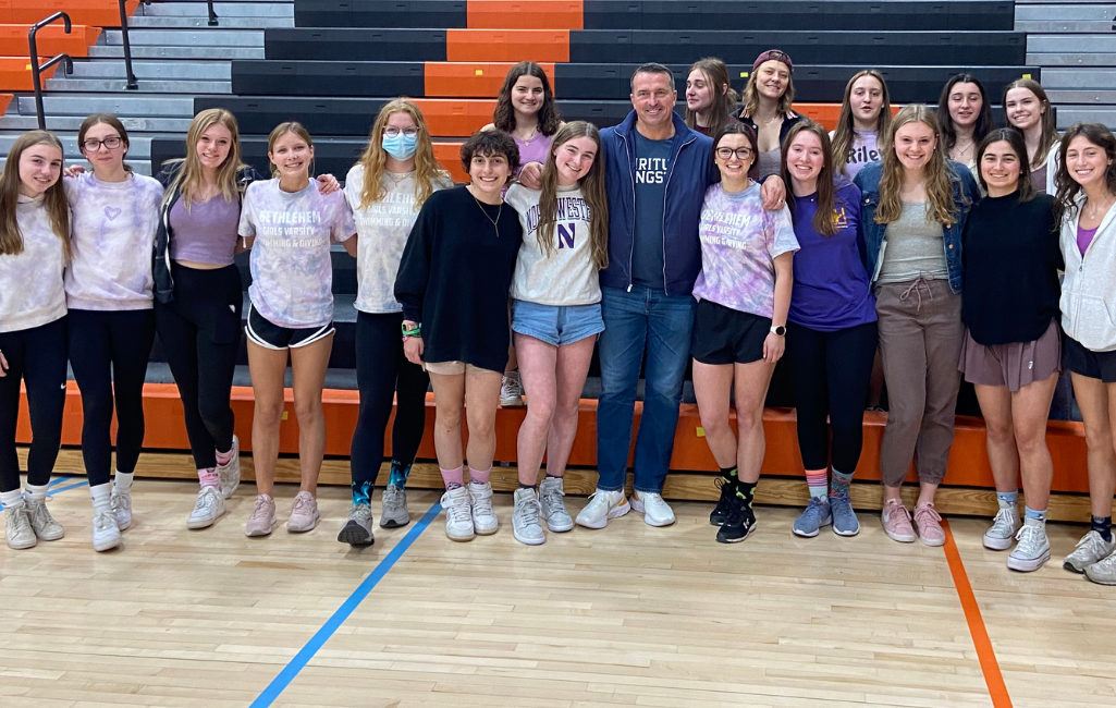 group of students pose for photo with guest speaker