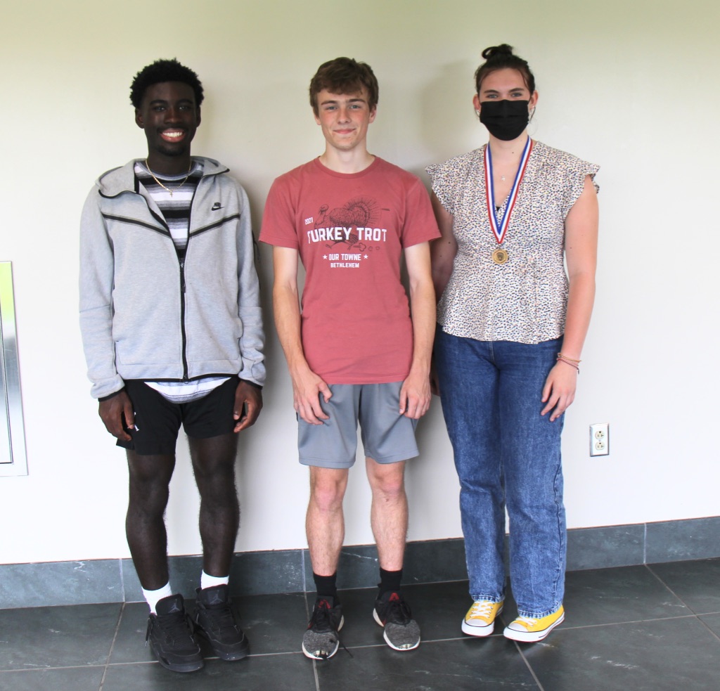 three students pose for photo