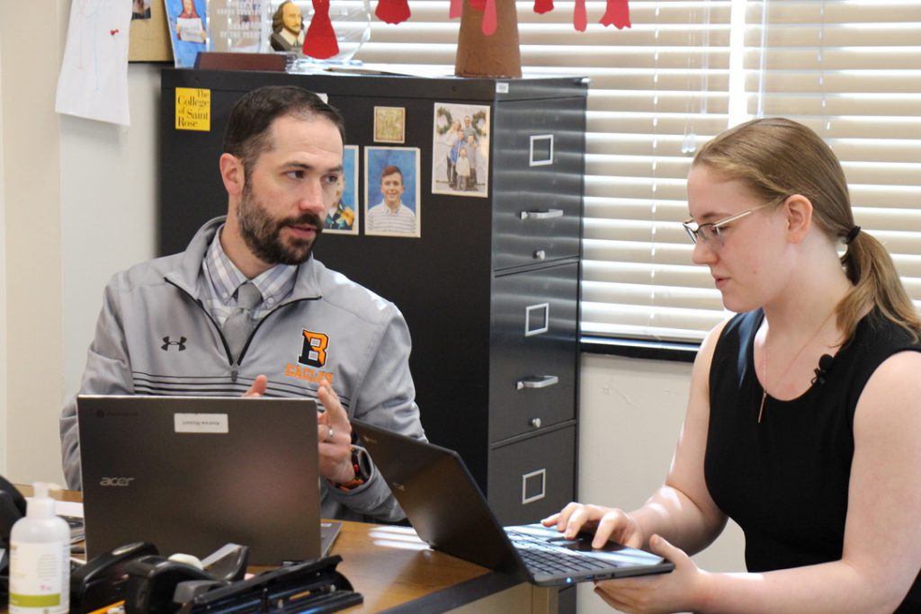 student and teacher with laptop computers