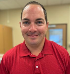 person in red shirt smiling