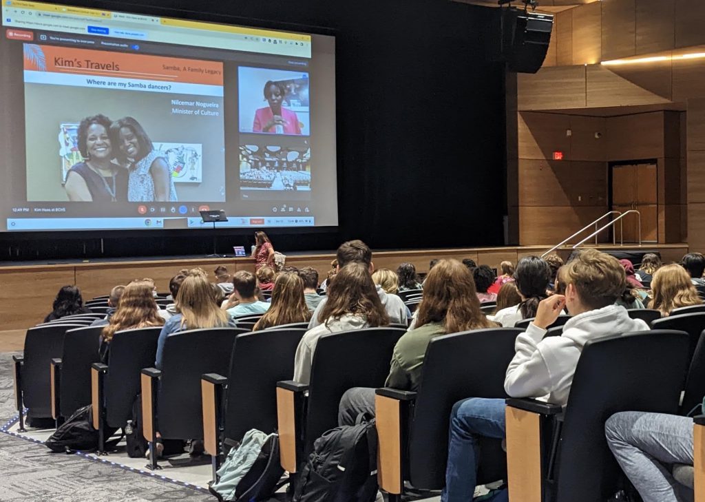 students in auditorium look at screen