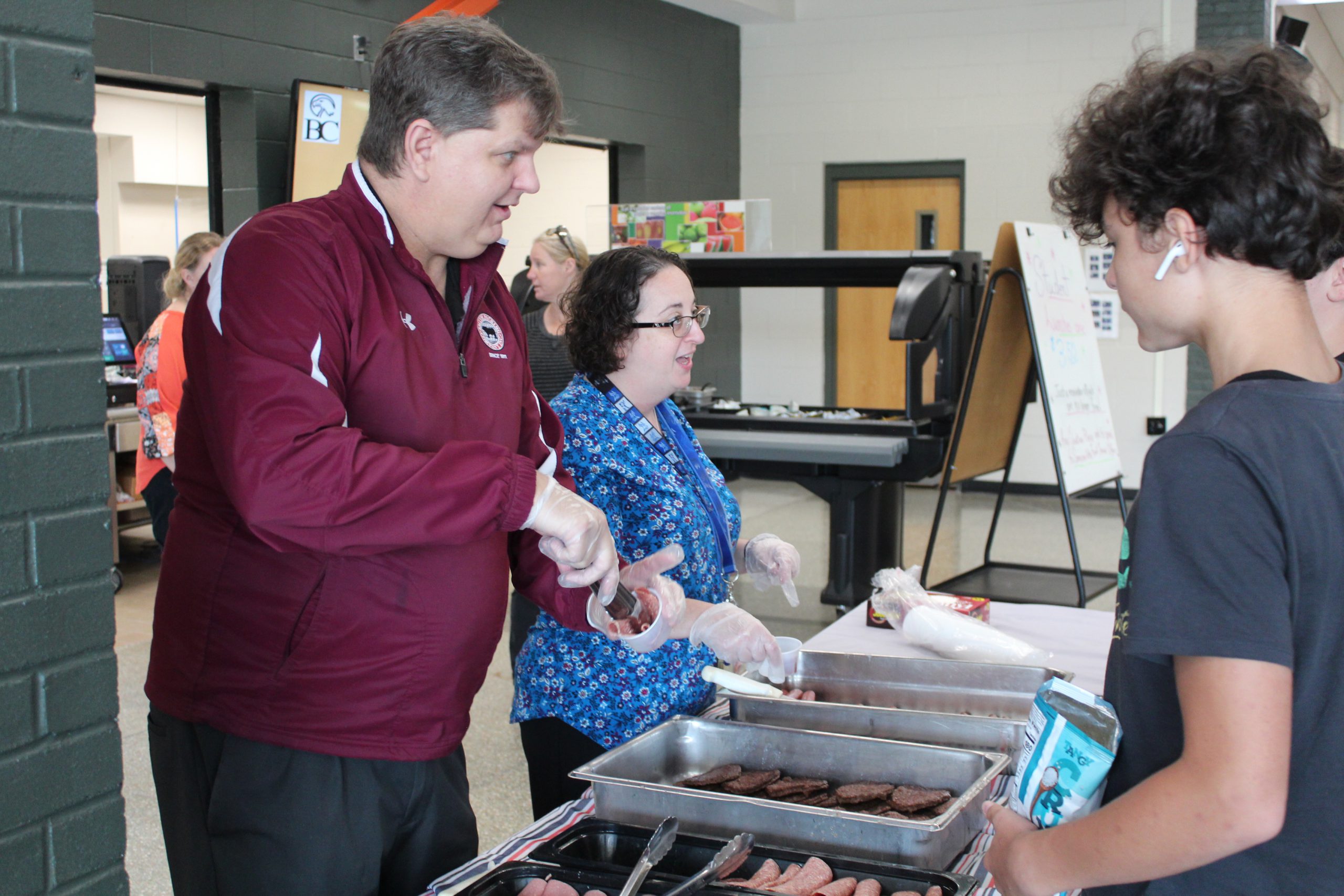 A representative from Smith Packing Company and BC Food Services Director Jaclyn Adler serve NYS Beef samples