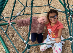 two students playing on playground