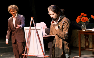 student actors on stage with easel and flowers