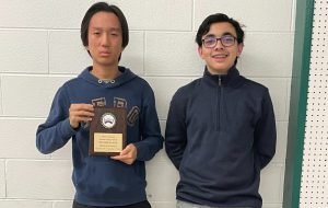 BC students Justin Mo and Zakir Bakar pose with second place plaque after performance at the history bowl competition in Syracuse.