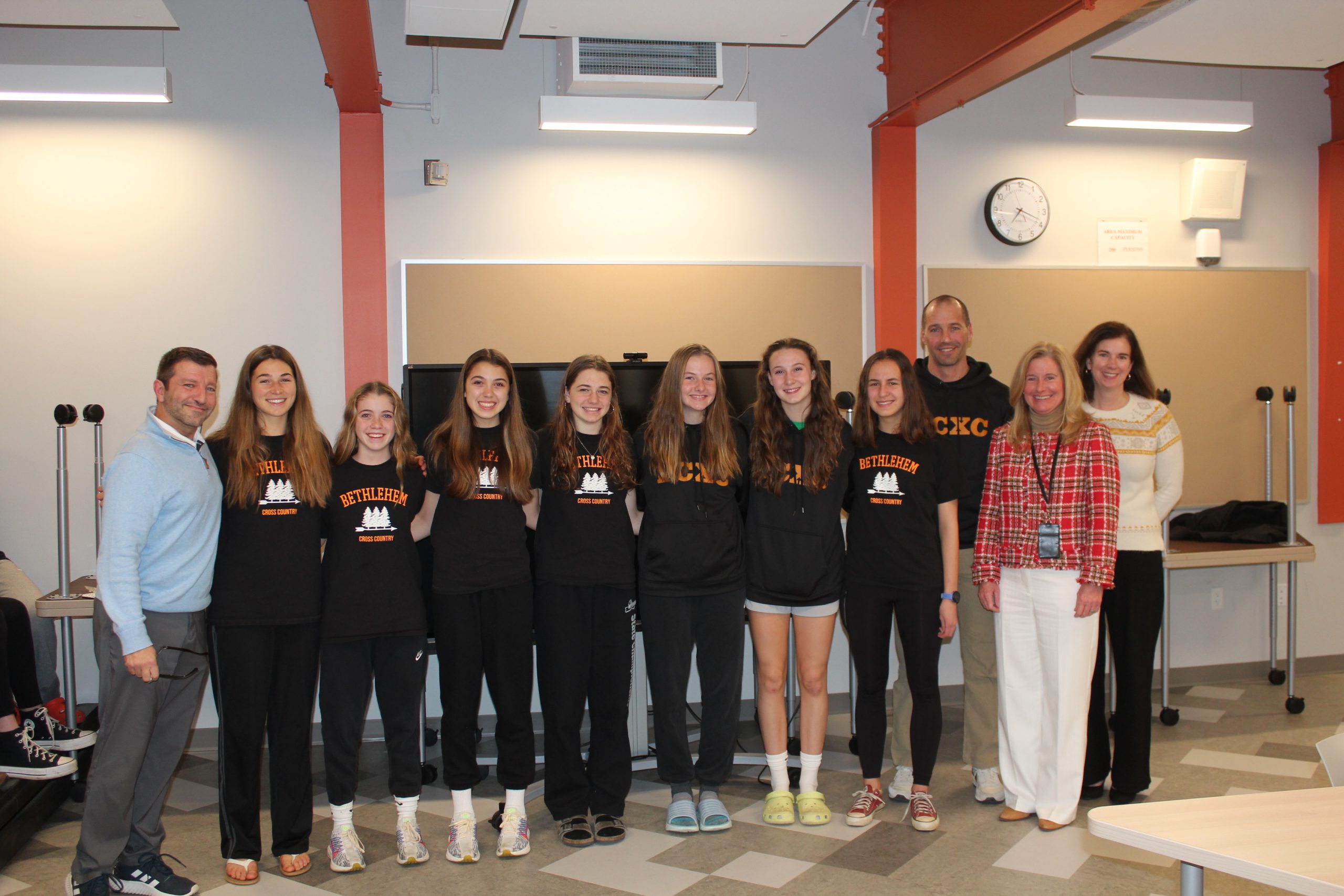 Girls Cross Country Team pictured with Athletic Director Len Kies, Superintendent Jody Monroe, and Board President Holly Dellenbough