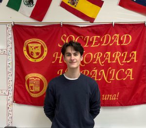 student standing in front of red flag