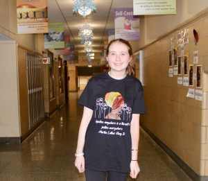 student wearing t-shirt in school hallway