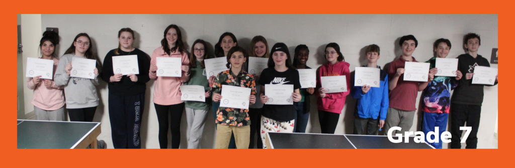 group of seventh graders holding certificates