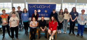 group of students pose with author