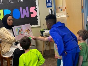 students looking closely at book