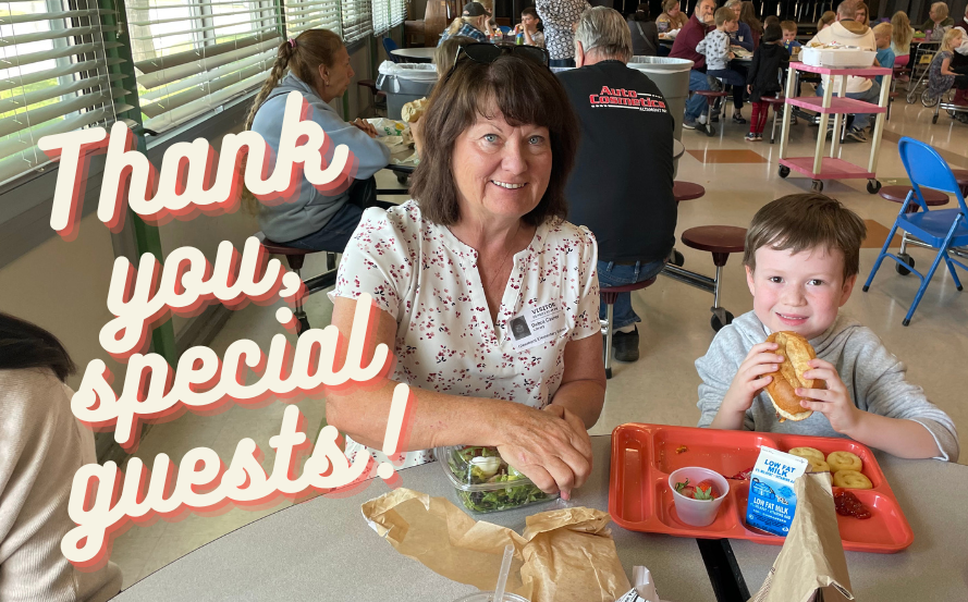 adult and child eating lunch in cafeteria