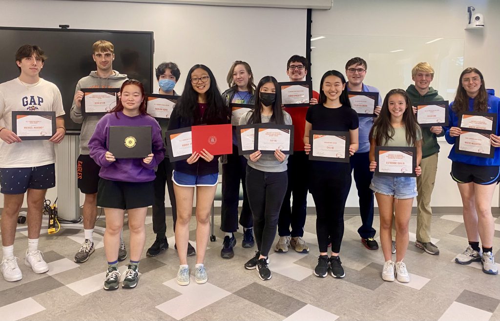 group of students holding certificates