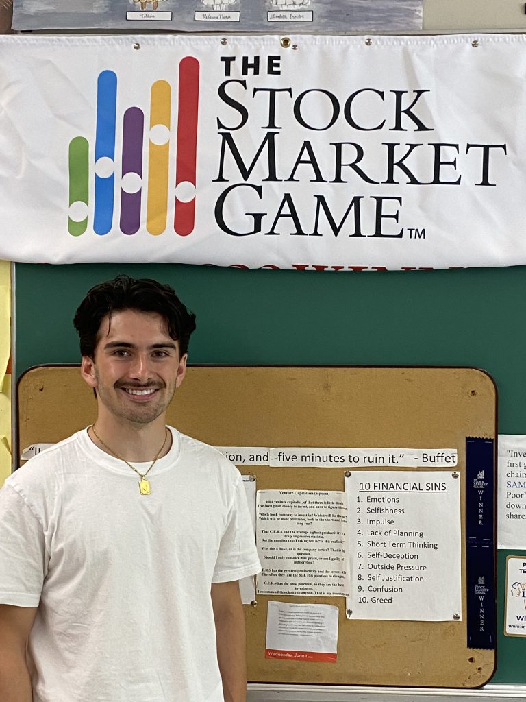 student standing next to bulletin board