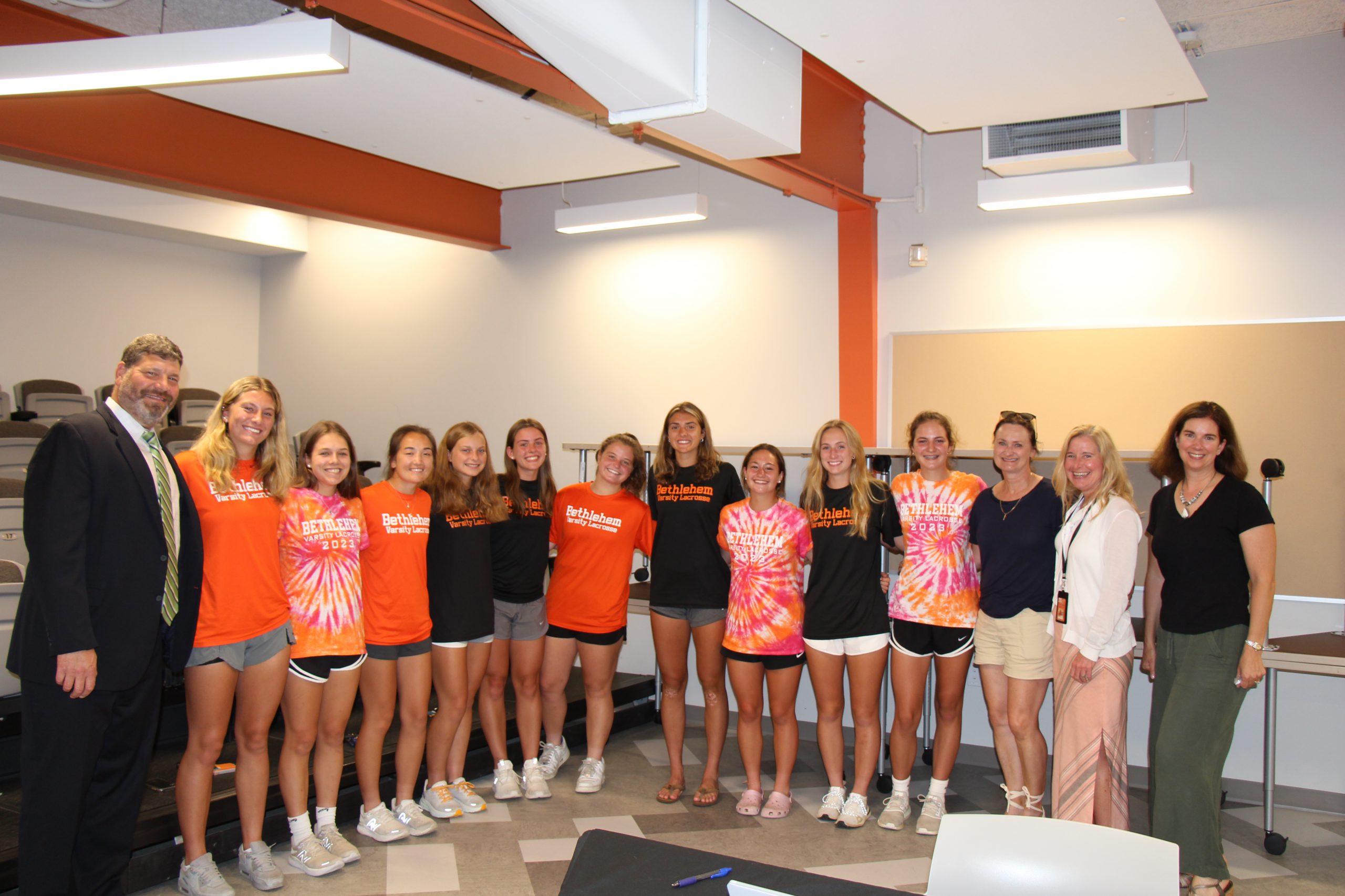 The Girls Lacrosse Team poses with Board Member Robert Tietjen, Superintendent Jody Monroe and Board President Holly Dellenbaugh.