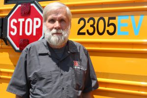 person standing in front of school bus