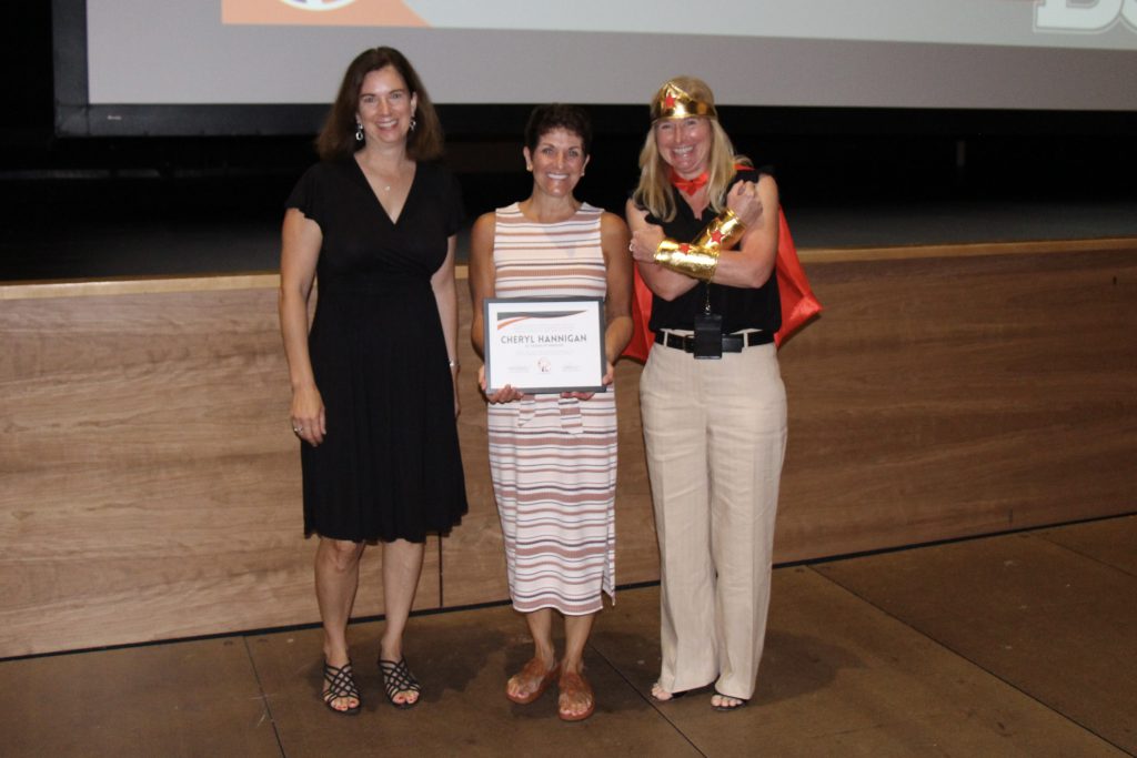 three people pose for photo, one holds certificate