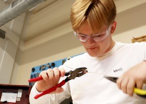 student working with pliers and wire