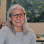 woman sitting at desk smiling
