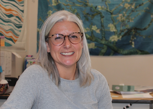 woman sitting at desk smiling