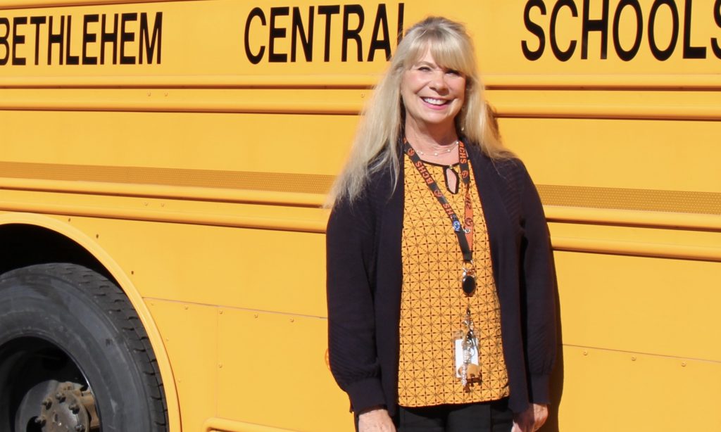 person standing in front of school bus