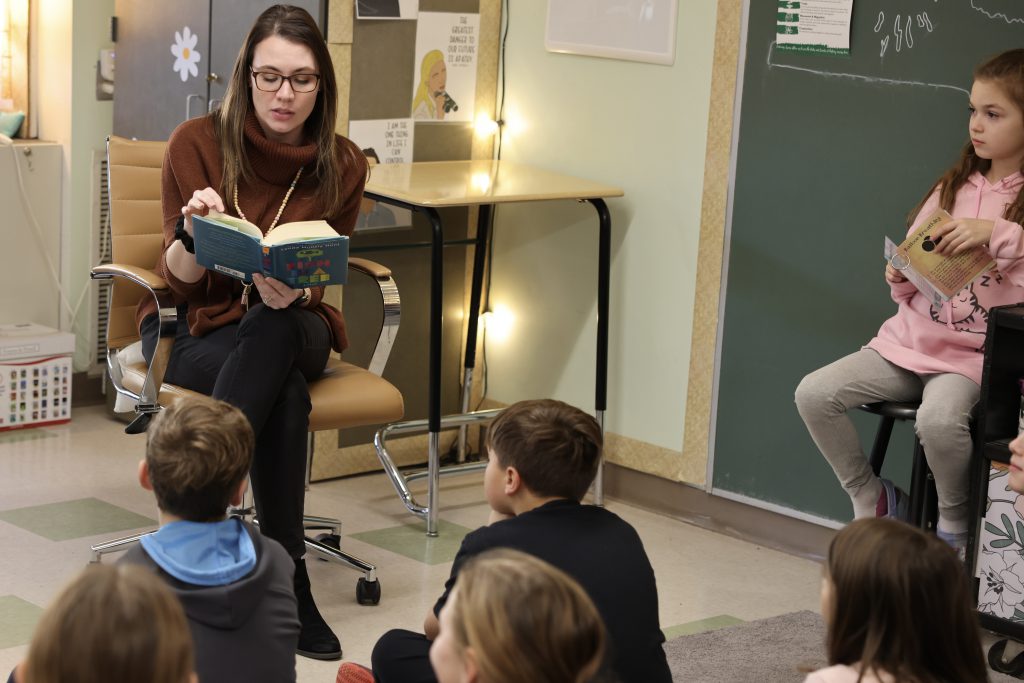 teacher reads book to students