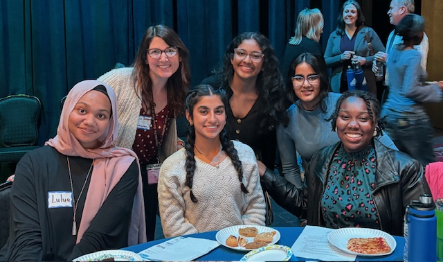 group of students with their teacher; all are smiling