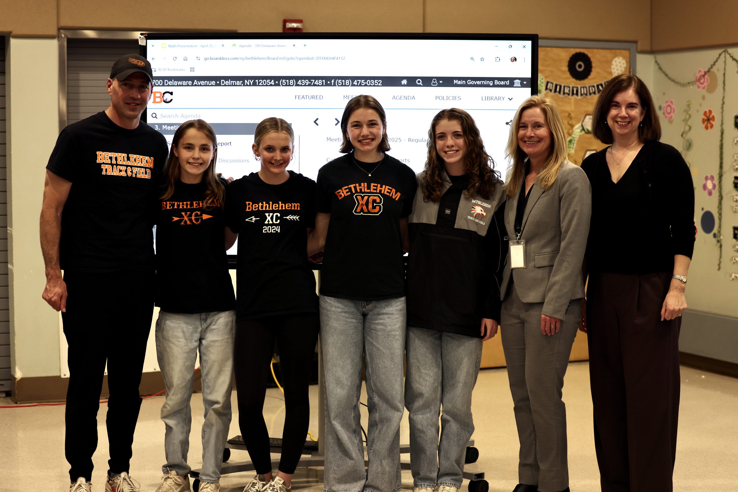 Photo of the Girls Indoor Track & Field Team with Superintendent Monroe and Board of Education President Holly Dellenbaugh
