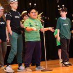 students performing on stage