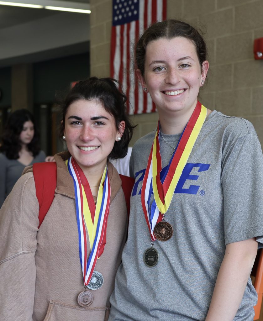two students wearing medals