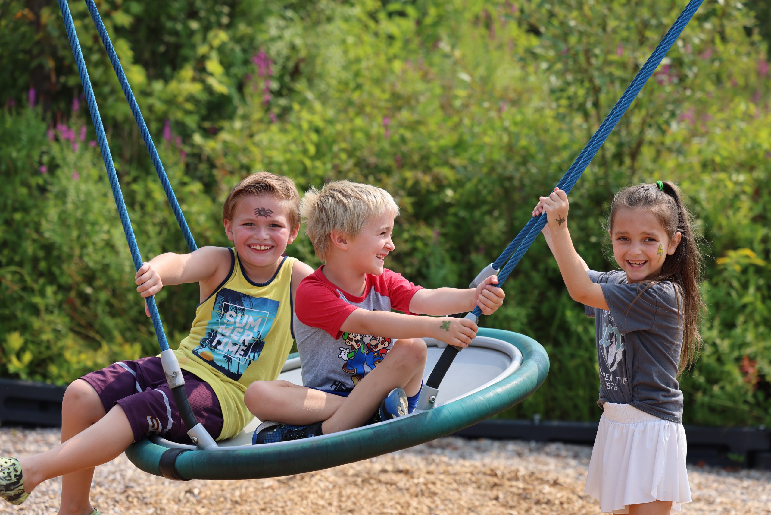 students on a tire swing