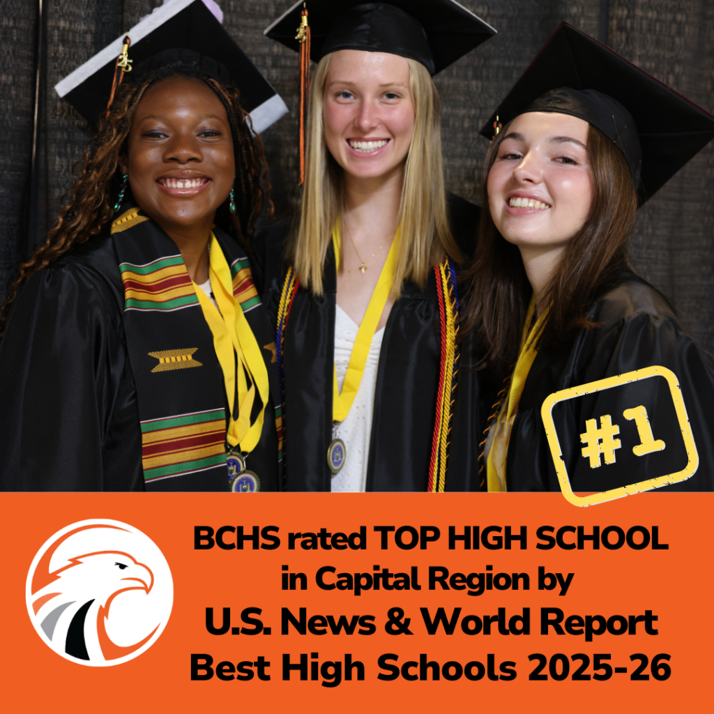 three students in caps and gowns