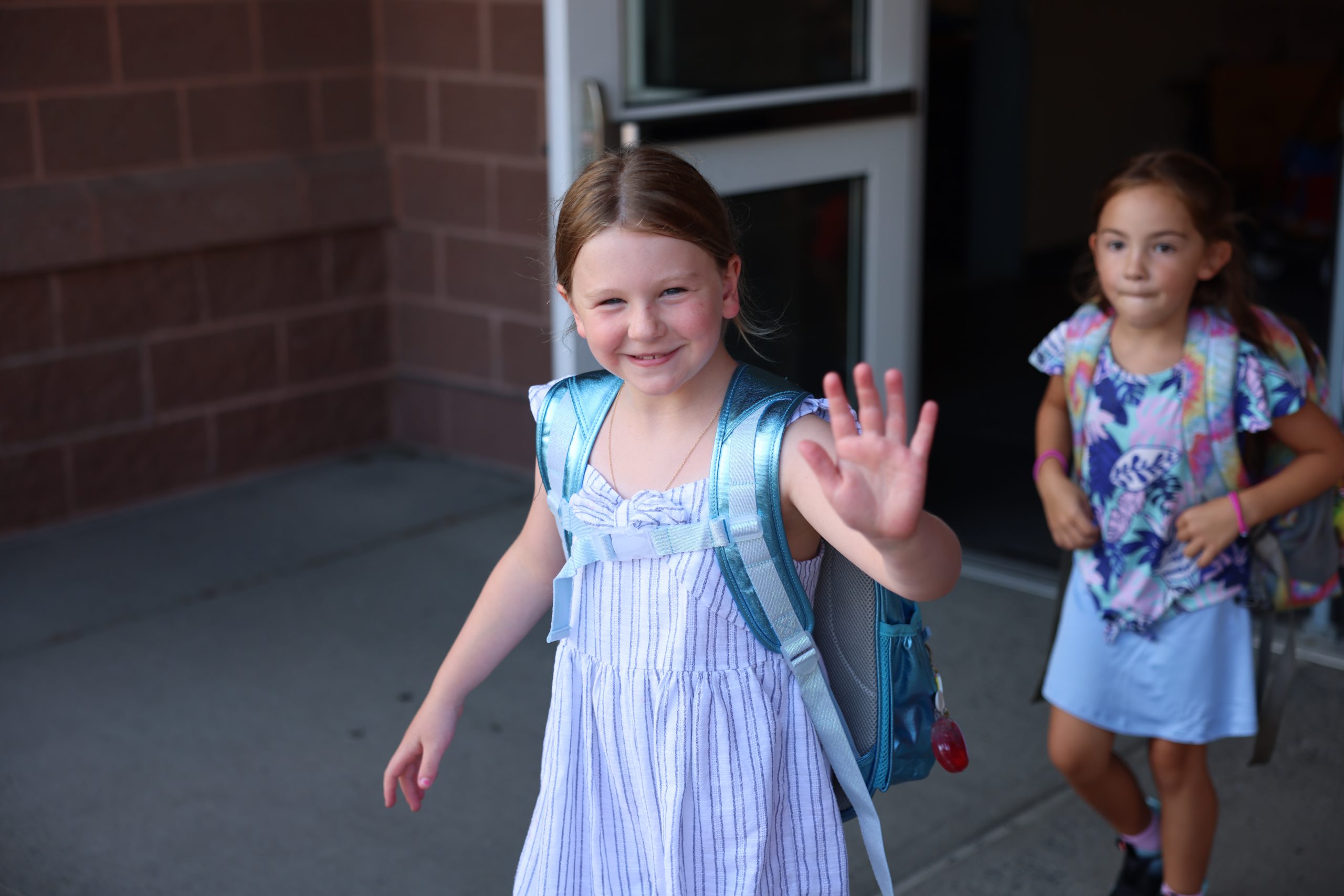 student waving