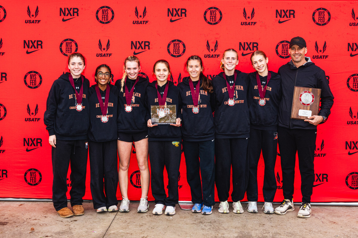 Image of the 2025 BC varsity girls cross country team with Head Coach Tucker Chrapowitzky