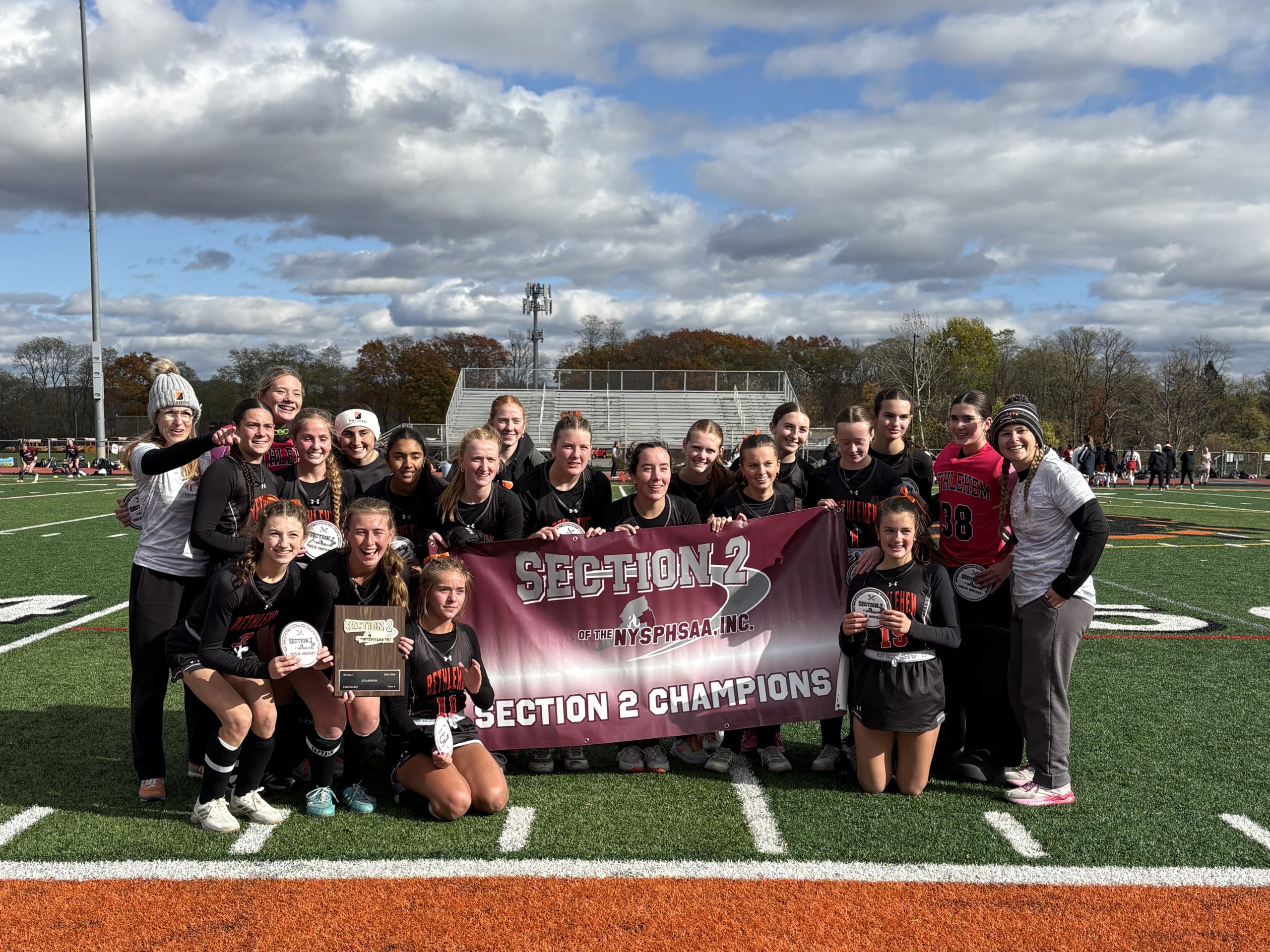 Image of girls varsity field hockey team and coaches.