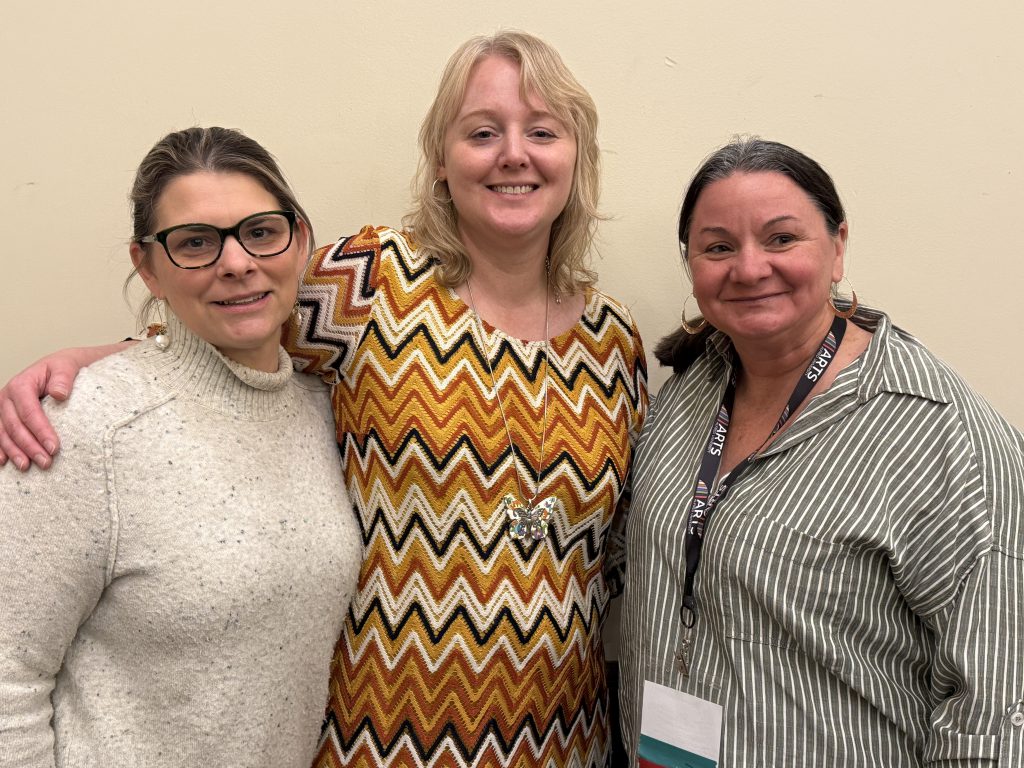 three people pose for photo