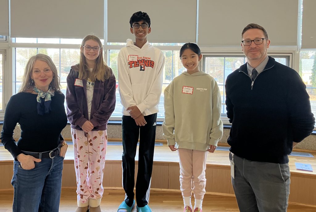 five people pose for photo