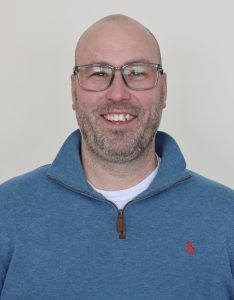 person in blue shirt smiling