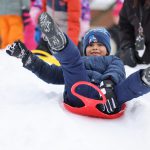 student on a sled in snow