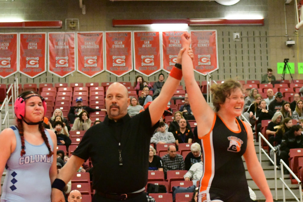 wrestler is named winner with arm raised