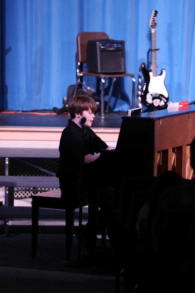 student plays piano