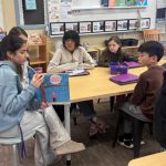 high school student reads to elementary students