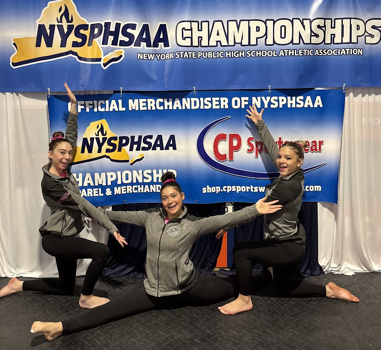 student athletes pose in front of banner